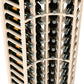 Close-up of white 4-column curved corner wine rack holding wine bottles