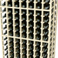 Close-up of two-deep 7-column wine rack, whitewashed wood bottle holders