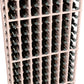 Close-up of white wine bottle rack showing rows of bottles in square slots