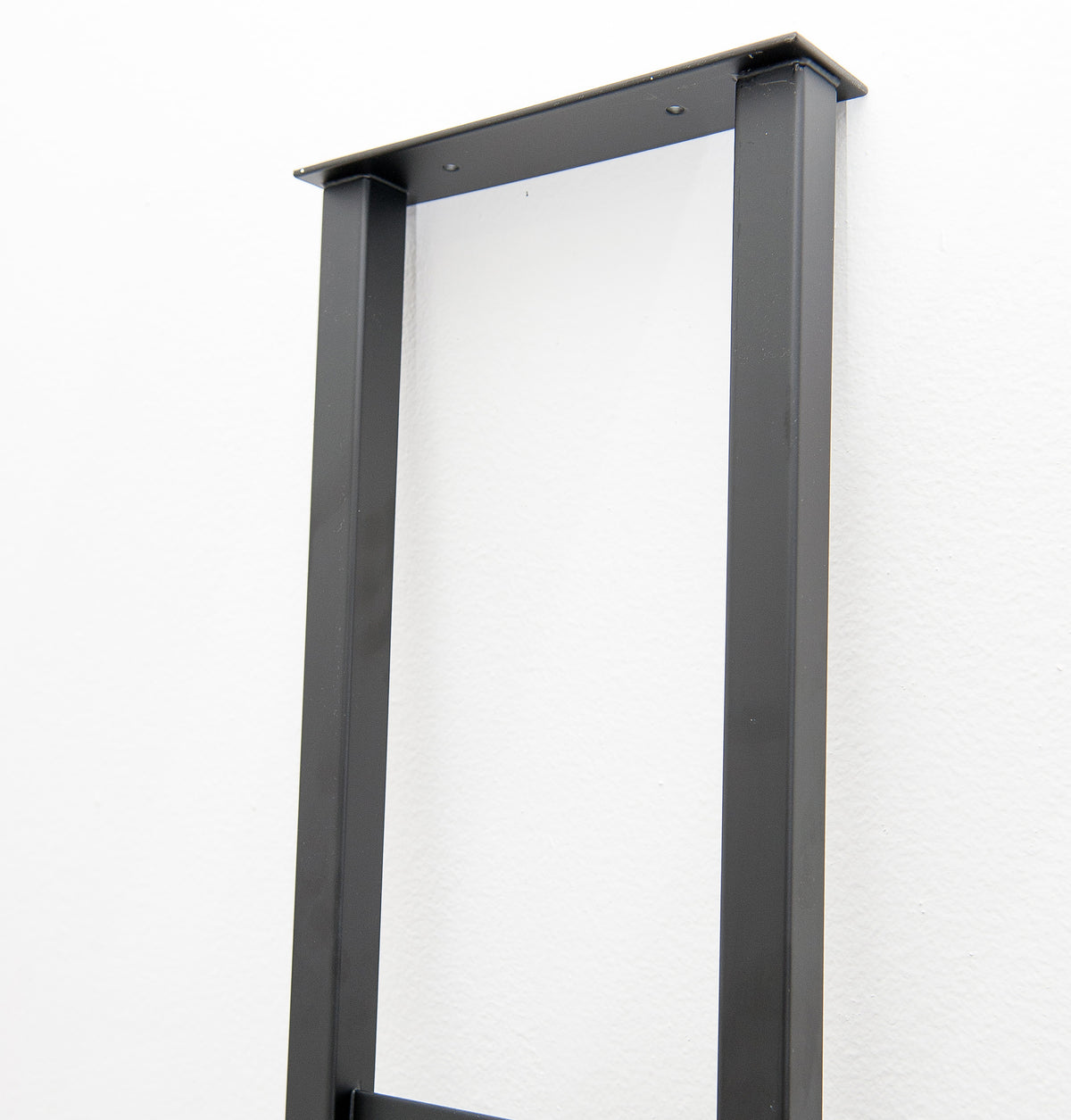 Floating wall frame top bracket in dark gunmetal metal, with mounting holes