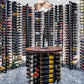 Double-sided wine rack display with stacked wine bottles and a central wooden stand