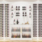 Wine bottle wall display with many perches holding bottles in a grid arrangement