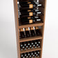 Wood wine cabinet with front bottle rails, shelf for bottles, and lower holder grid