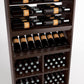 Wood wine rack display with bottle rails, angled wine shelf, and grid-pattern bins