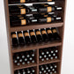 Wood wine rack with bottle rails, angled bottle shelf, and grid-pattern bottle bins