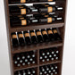 Wine bottle rack close-up showing six rails above a multi-cell wine bin with bottle necks