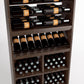Wine rack close-up with bottle rails and lower bin compartments holding wine bottles