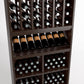 Wood wine rack close-up featuring arched bottle slots, angled wine bottles, and storage bins