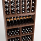 Wood wine rack close-up with bottle cubbies, angled wine bottles, and multiple cubby rows