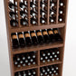 Light wood wine rack close-up showing bottle compartments, front display shelf, and cubbies.