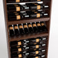 Detail of wine bottle rack with dark wood dividers, bottle rails, and a lower row of bottles