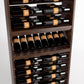 Close-up of dark wood wine rack with bottle neck rails and staggered bottle storage
