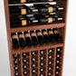 Brown wood wine rack shelves with horizontal bottle rails above a glass-front bottle display