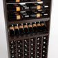 Brown wood wine rack close-up: top bottle rails, middle angled bottle rows, and bottom cubbies
