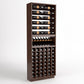 Brown wood wine rack cabinet with top bottle rails, black bottle cradle, and lower bottle slots