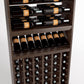 Wood wine rack interior with top bottle rails, slatted cradles, and front wine bottle cubbies