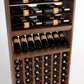 Wood wine rack interior with top bottle rails, slotted display shelf, and front wine cubbies