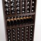 Close-up of wine bottle rack with front label bottles in cubby slots and shelf