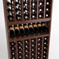 Close-up view of wine bottle rack with cubbies and a bottle tray below