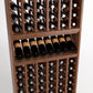 Angled wood wine bottle rack view with front shelf row and lower bottle compartments