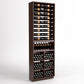 Tall wine bottle display rack with six bottle rails, curved holder, and lower bin grid