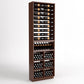 Tall dark wood wine storage cabinet with bottle racks, glass holders, and wine bins