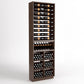 Wood wine display rack with six bottle rails, curved bottle holder, and lower bottle bin cells
