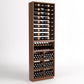 Dark wood wine storage cabinet with organized bottle display, glass holders, and wine bins