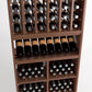 Wood wine rack section with upright bottles in column slots and lower storage shelves