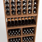 Wood wine rack section showing column bottle slots and lower shelves with boxed bottles