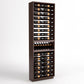Dark wood wine bottle display rack with six-column rails and a curved bottle holder