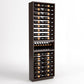 Full view of dark wood wine bottle display rack with bottle rails and center holder row