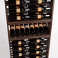 Wood wine rack interior with rows of bottles in horizontal slots and a mid shelf