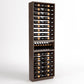 Tall wood wine bottle display rack with 6 columns and a curved bottle tray