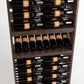 Wood wine bottle display rack close-up of lower shelves with dark wine bottles.