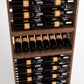 Close-up of a wood wine rack showing bottle rows, front slots, and a curved base tray