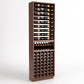 Tall dark wood wine rack cabinet with top rails, bottle cradles, and front cubby rows