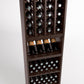 Dark wood wine rack showing front bottle rows with labeled bottles and empty display shelves