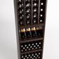 Dark brown wood wine rack showing bottle cubbies above shelves with bottles and neat rows