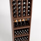 Brown wood wine rack close-up with grid bottle cubbies, wine bottles, and storage shelves