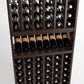 Wood wine bottle rack close-up with upright bottles and a middle wine display shelf