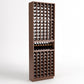 Light brown wood wine bottle cellar rack with bottle slots and a center bottle display shelf