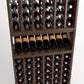 Wood wine bottle rack close-up with upright bottles and rows of display compartments