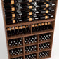 Wood wine rack close view with bottles on rails, shelf rows, and lower square bottle compartments
