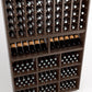 Wood wine rack showing angled bottle rows above cubbies filled with wine bottles