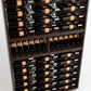 Close-up view of dark wood wine bottle rack shelves filled with bottles