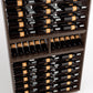 Close-up of wine bottle rails in a dark wood 9-column wine rack cabinet