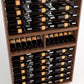 Close-up of wine bottle storage rails in a dark wood 9-column wine rack cabinet