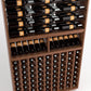 Wine rack close-up showing bottles on upper rails and lower cube-style bottle storage