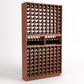Dark wood wine bottle rack with 9 columns, two upper bottle cradles, and rows of wine bottles